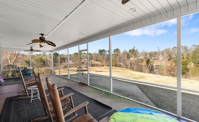 unfurnished sunroom with ceiling fan