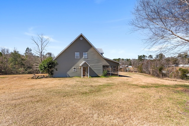 back of property featuring a yard