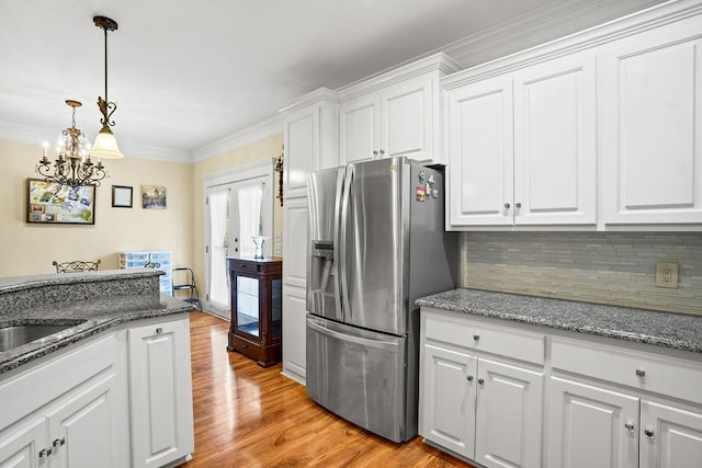 106 Camberly Ct, Dothan, AL 36301 - kitchen with stainless steel fridge with ice dispenser, white cabinetry, backsplash, light wood-style floors, and crown molding