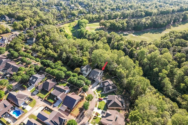 drone / aerial view with a residential view and a wooded view