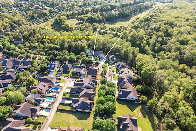 aerial view featuring a residential view and a wooded view