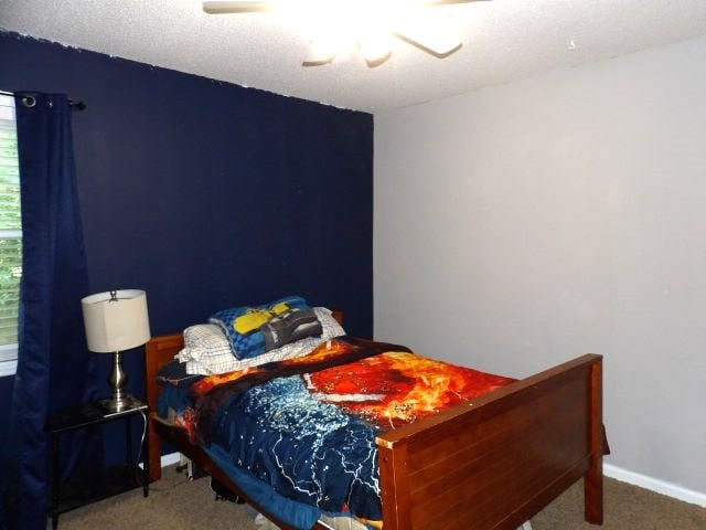 bedroom featuring ceiling fan and carpet floors