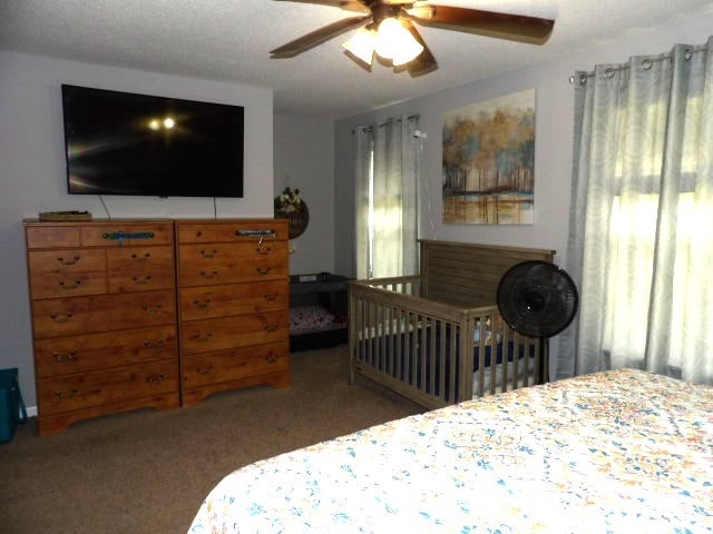 bedroom featuring ceiling fan and carpet