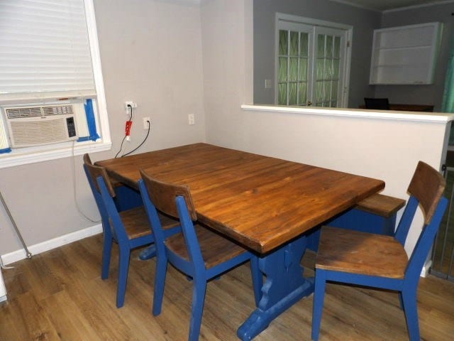 dining area featuring dark hardwood / wood-style flooring and cooling unit