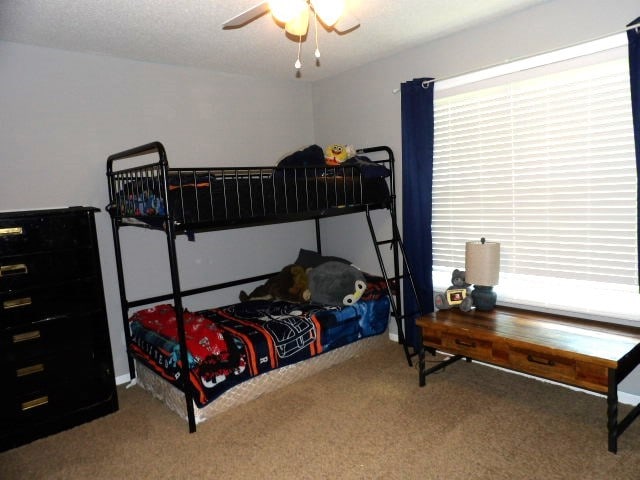 carpeted bedroom with ceiling fan