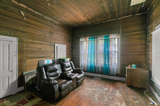 living area featuring wood walls and wood-type flooring
