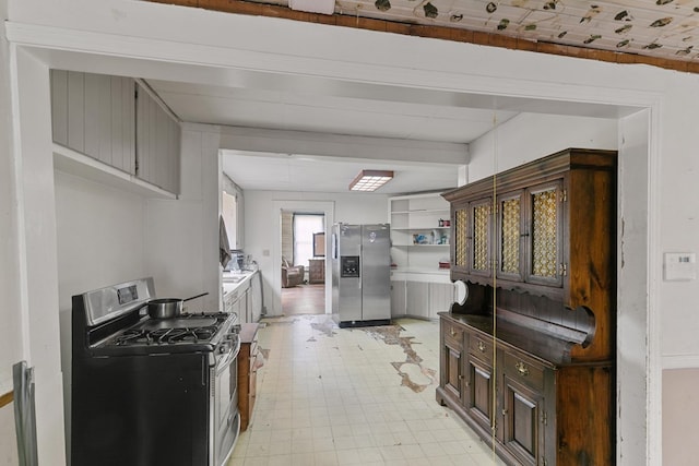 kitchen featuring open shelves, light floors, and stainless steel appliances