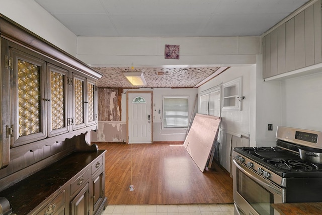 kitchen with gas range, dark countertops, and light wood-type flooring