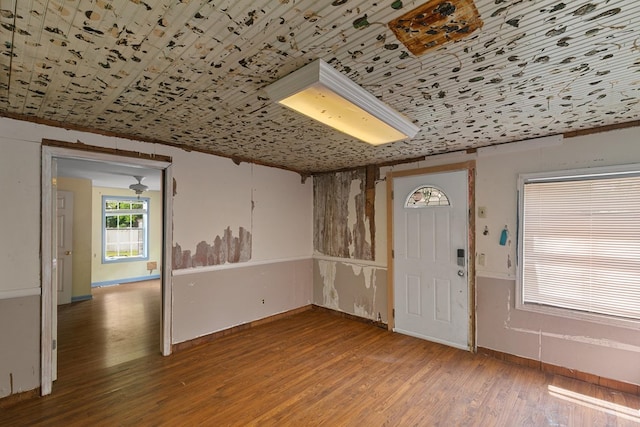 entrance foyer featuring baseboards and wood finished floors