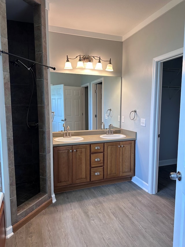 183 Chestnutt Rd, Slocomb, AL 36375 - bathroom with double vanity, wood finished floors, and tiled shower