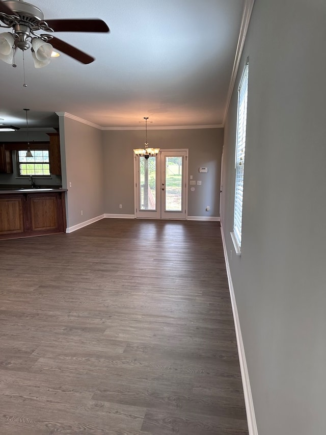 183 Chestnutt Rd, Slocomb, AL 36375 - unfurnished living room featuring crown molding, plenty of natural light, a ceiling fan, a chandelier, and dark wood-style floors