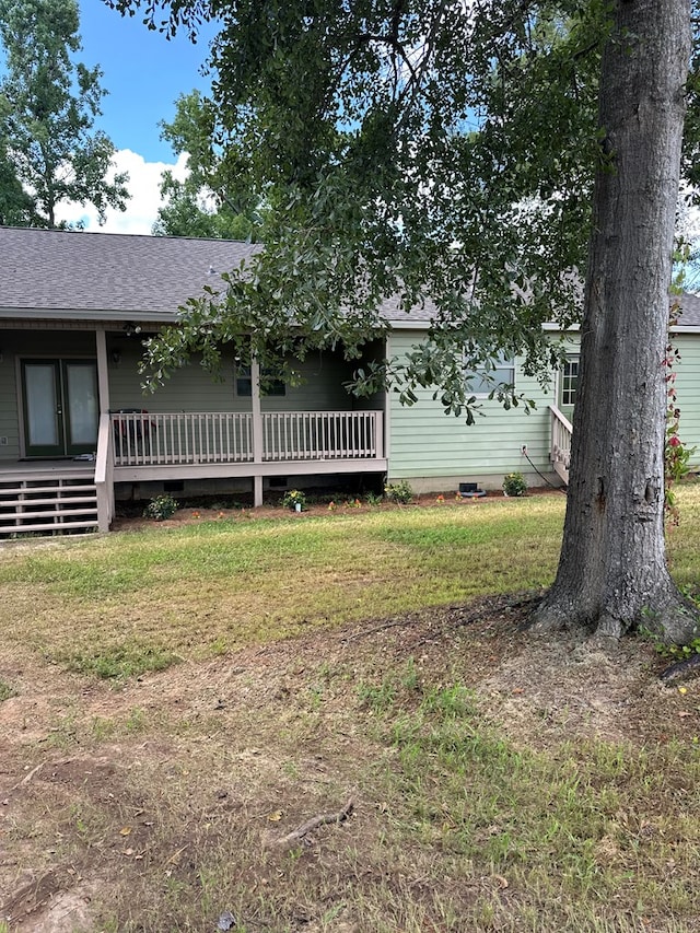 183 Chestnutt Rd, Slocomb, AL 36375 - view of front of home with a front yard, a wooden deck, roof with shingles, and crawl space