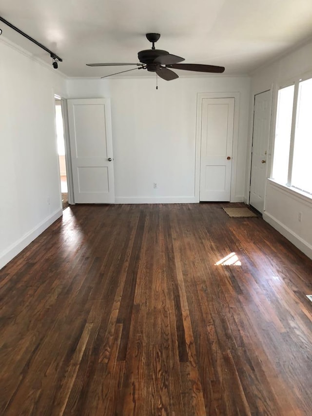 empty room with dark hardwood / wood-style floors and ceiling fan