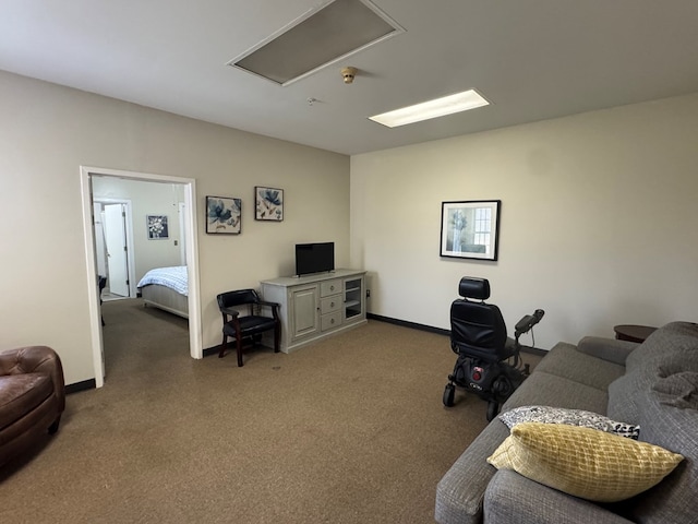 home office featuring carpet floors, attic access, and baseboards