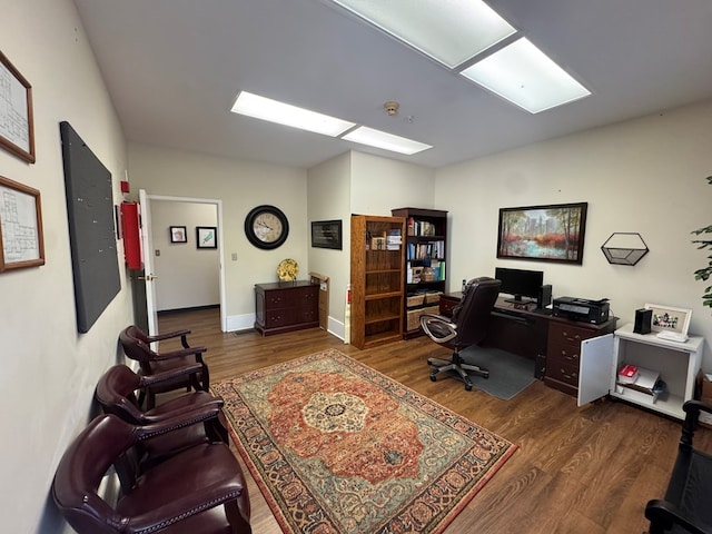 home office with wood finished floors and baseboards