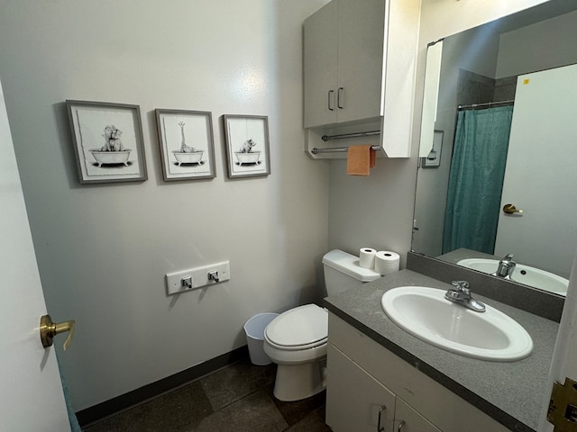 bathroom with curtained shower, toilet, vanity, baseboards, and tile patterned floors