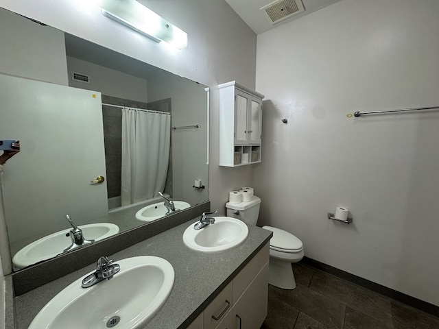 bathroom featuring visible vents, a sink, and toilet