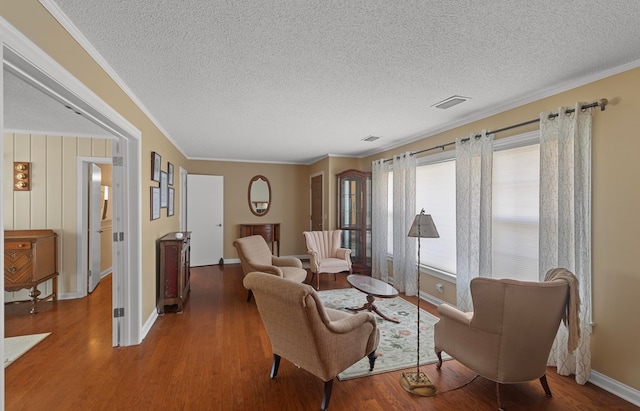 living room featuring a textured ceiling, dark wood-type flooring, and crown molding