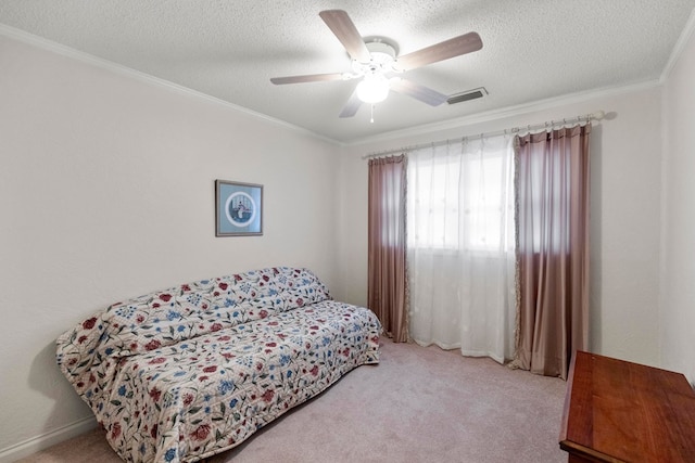 bedroom with light carpet, ceiling fan, a textured ceiling, and ornamental molding