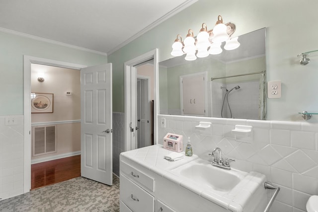 bathroom featuring a shower with curtain, tile walls, tile patterned floors, ornamental molding, and vanity