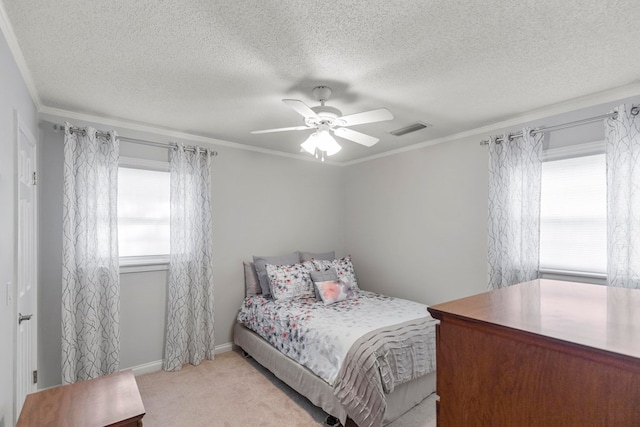 carpeted bedroom with a textured ceiling, ceiling fan, and crown molding