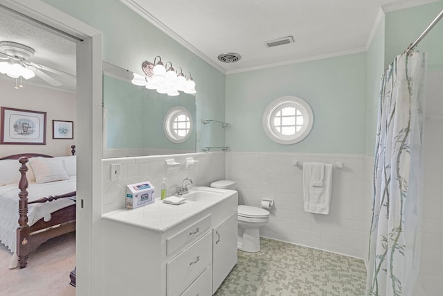 bathroom featuring a textured ceiling, tile walls, ceiling fan, walk in shower, and vanity