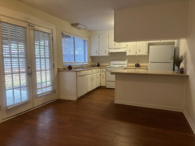 kitchen with dark hardwood / wood-style flooring, white appliances, white cabinetry, and french doors