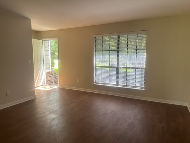 spare room featuring dark hardwood / wood-style floors