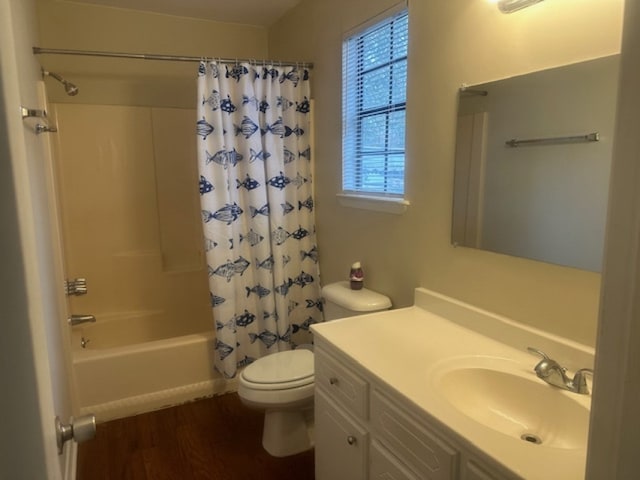 full bathroom featuring hardwood / wood-style floors, vanity, toilet, and shower / bathtub combination with curtain