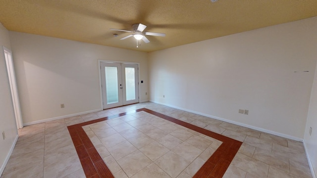 spare room with ceiling fan, a textured ceiling, and french doors