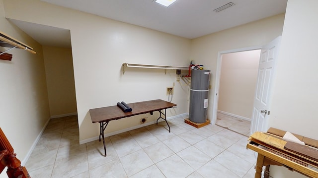 miscellaneous room featuring electric water heater and light tile patterned flooring