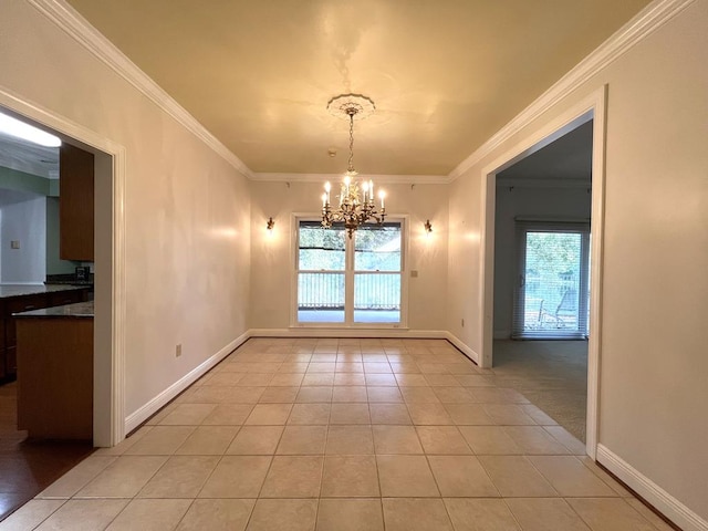 unfurnished dining area featuring plenty of natural light, crown molding, and an inviting chandelier