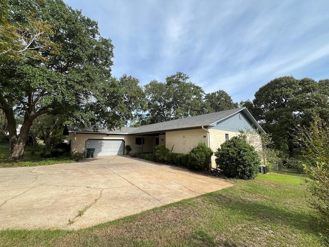 view of front of house with a garage and a front yard