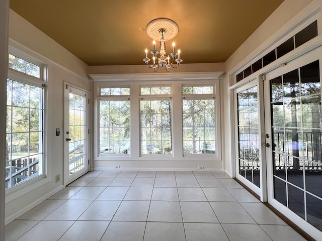 unfurnished sunroom with plenty of natural light and a notable chandelier