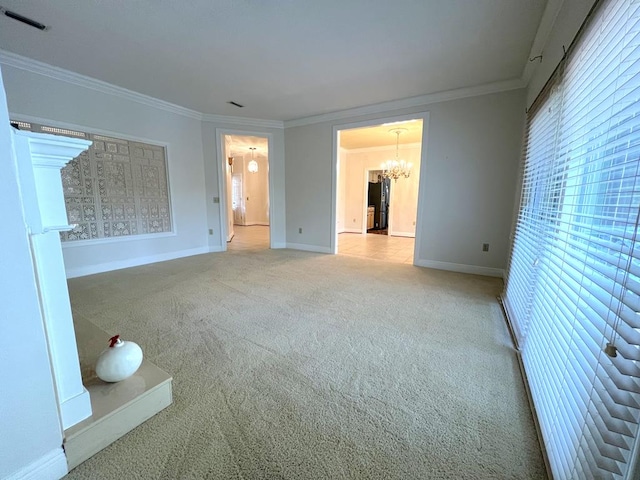 empty room with crown molding, light carpet, and a notable chandelier