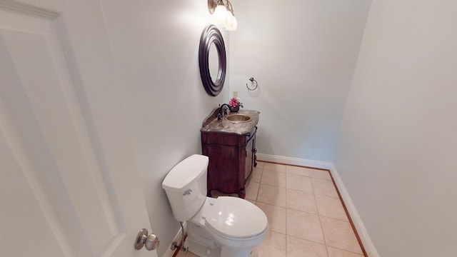 bathroom featuring tile patterned flooring, vanity, and toilet