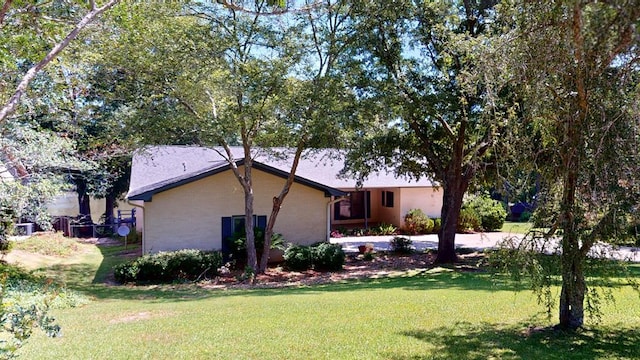 view of side of property with a lawn