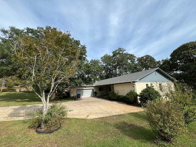 ranch-style house featuring a front yard and a garage