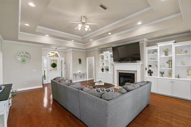 106 Lake Ln, Headland, AL 36345 - living room featuring a raised ceiling, a ceiling fan, a fireplace, dark wood finished floors, and baseboards