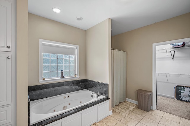 106 Lake Ln, Headland, AL 36345 - full bathroom featuring tile patterned floors, a whirlpool tub, a spacious closet, and curtained shower