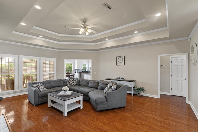 106 Lake Ln, Headland, AL 36345 - living area featuring a tray ceiling, ceiling fan, wood finished floors, ornamental molding, and baseboards