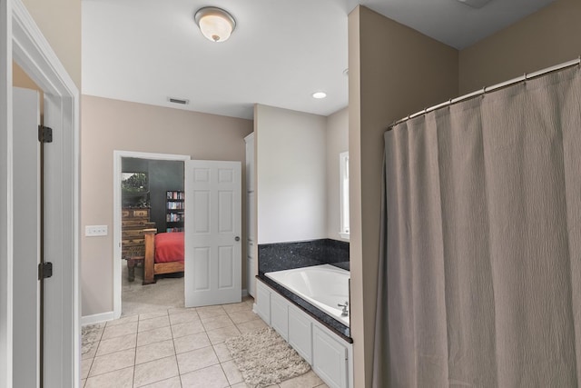 106 Lake Ln, Headland, AL 36345 - bathroom featuring a garden tub, tile patterned floors, and baseboards