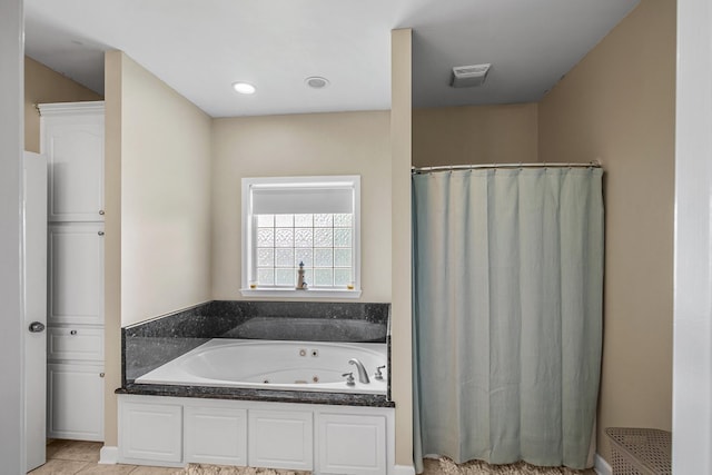106 Lake Ln, Headland, AL 36345 - bathroom with a whirlpool tub, a shower with curtain, and tile patterned flooring