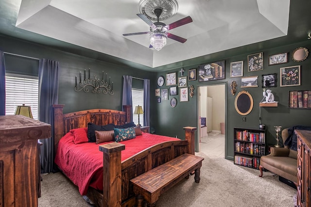 106 Lake Ln, Headland, AL 36345 - bedroom featuring a tray ceiling, carpet flooring, ensuite bath, and a ceiling fan