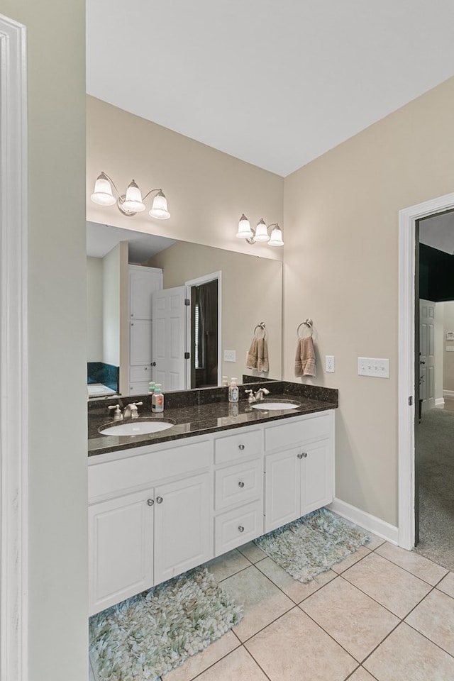 106 Lake Ln, Headland, AL 36345 - bathroom with double vanity, tile patterned floors, and baseboards