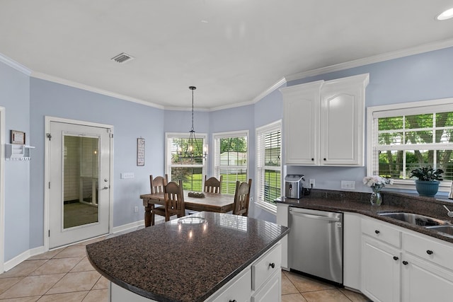 106 Lake Ln, Headland, AL 36345 - kitchen with stainless steel dishwasher, light tile patterned flooring, white cabinetry, a center island, and ornamental molding
