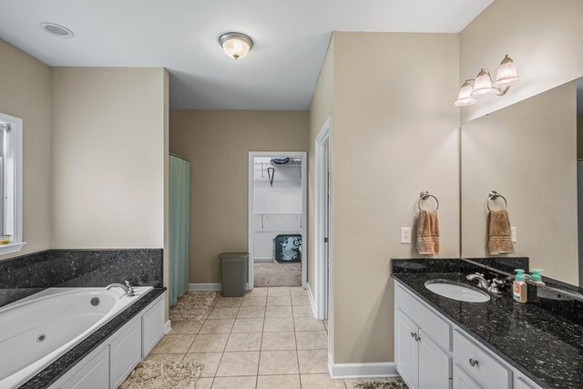 106 Lake Ln, Headland, AL 36345 - full bathroom with vanity, a spacious closet, a tub with jets, a shower with shower curtain, and tile patterned floors