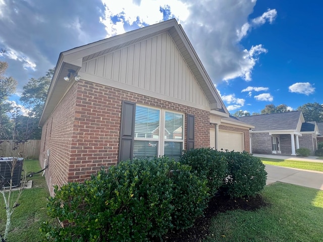 view of side of home featuring central AC unit and a garage