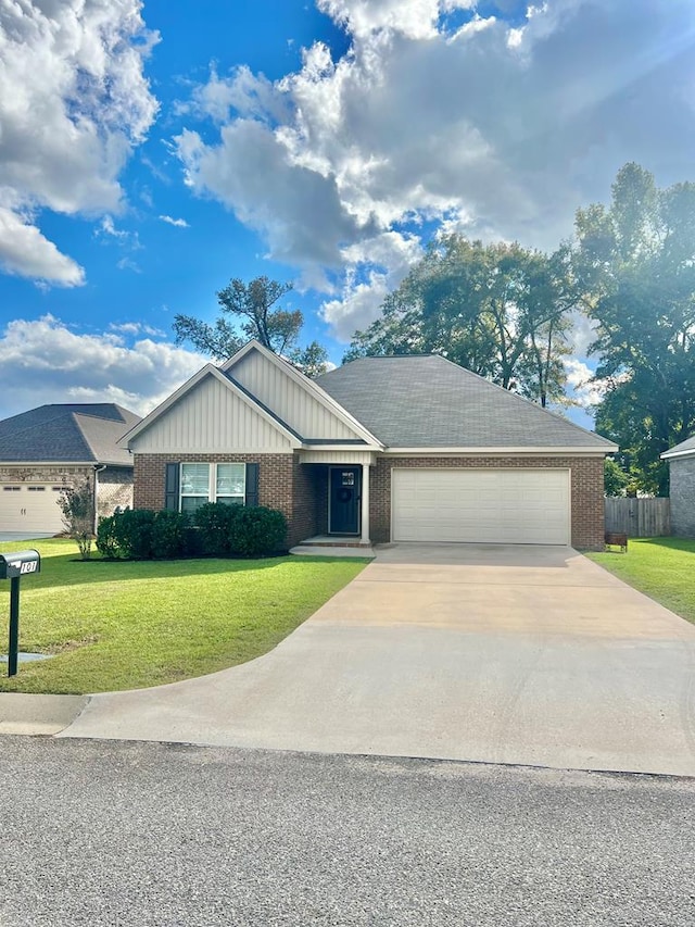 view of front of home with a garage and a front lawn