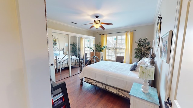 bedroom with crown molding, dark wood-type flooring, and ceiling fan